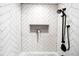 Modern bathroom with a stylish subway tile shower and sleek, black fixtures at 3842 Zenobia St, Denver, CO 80212