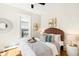 Bright bedroom with modern decor, a decorative mirror, and hardwood floors at 3842 Zenobia St, Denver, CO 80212