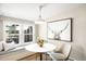 Cozy dining nook with built-in bench seating, modern lighting, and an interesting art piece at 3842 Zenobia St, Denver, CO 80212