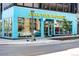 Bright turquoise commercial building with large windows and street access at 3842 Zenobia St, Denver, CO 80212