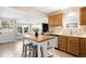 Functional kitchen featuring an island with seating, wood cabinets, and modern appliances at 3842 Zenobia St, Denver, CO 80212