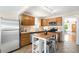 Spacious kitchen with a kitchen island, stainless steel appliances, and light wood cabinetry at 3842 Zenobia St, Denver, CO 80212