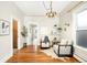 Bright living room with hardwood floors, chandelier and stylish decor. Perfect for entertaining at 3842 Zenobia St, Denver, CO 80212