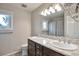 Bathroom featuring double sinks, granite countertop and neutral colors at 8958 Forrest Dr, Highlands Ranch, CO 80126