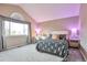 Bedroom featuring large window, desk, accent lighting and carpeted flooring at 8958 Forrest Dr, Highlands Ranch, CO 80126