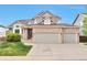 Beautiful two-story home with a brick facade and a spacious two car garage, set against a clear blue sky at 8958 Forrest Dr, Highlands Ranch, CO 80126