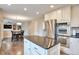 Open-concept kitchen featuring granite countertops, stainless steel appliances, and a central island with views to dining area at 8958 Forrest Dr, Highlands Ranch, CO 80126
