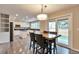Bright kitchen and dining area with white cabinetry, stainless steel appliances, and sliding glass doors to the deck at 8958 Forrest Dr, Highlands Ranch, CO 80126