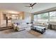 Bright living room with a large sectional couch and view of the kitchen, creating an open and inviting space at 8958 Forrest Dr, Highlands Ranch, CO 80126