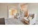 Bright living room features neutral paint, light-colored carpet and access to the home's elegant curved staircase at 8958 Forrest Dr, Highlands Ranch, CO 80126
