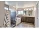 Bright main bathroom features a walk-in shower, soaking tub, and dual sink vanity at 8958 Forrest Dr, Highlands Ranch, CO 80126