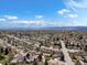 A high altitude aerial view of the neighborhood in spring shows a mature, leafy canopy and blue skies at 6500 S Downing St, Centennial, CO 80121