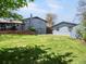 Large backyard with spacious lawn, detached garage, and mature trees at 6500 S Downing St, Centennial, CO 80121