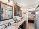 Bathroom highlighting granite countertop, double sinks and tiled shower at 6500 S Downing St, Centennial, CO 80121