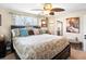 Spacious bedroom with ceiling fan, natural light, and decorative furnishings at 6500 S Downing St, Centennial, CO 80121