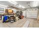 Spacious garage featuring work benches, storage cabinets, and a large garage door at 6500 S Downing St, Centennial, CO 80121