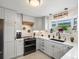 Updated kitchen showcasing gray cabinets, stainless steel appliances, and a stylish backsplash at 6500 S Downing St, Centennial, CO 80121
