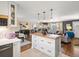 Bright, open-concept living room with hardwood floors, updated island, and ample natural light at 6500 S Downing St, Centennial, CO 80121