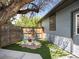 Cozy patio features artificial turf, mature tree, garden table and chairs, and privacy fence at 6500 S Downing St, Centennial, CO 80121