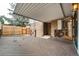 Covered back deck made of stained wood, with a view of the backyard and wooden fence at 9967 Lane St, Thornton, CO 80260