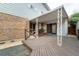 Covered back deck made of stained wood, with decorative metal support columns at 9967 Lane St, Thornton, CO 80260