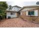 Backyard with brick siding, window shutters, and a ground cover of decorative rock at 9967 Lane St, Thornton, CO 80260