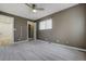 Bedroom featuring neutral walls, large windows with blinds and an ensuite closet at 9967 Lane St, Thornton, CO 80260