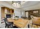 Open dining area with wood table, adjacent living room with fireplace, and accent wall at 9967 Lane St, Thornton, CO 80260