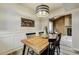 Bright dining room with wood table, decorative lighting, and an open view into the living room at 9967 Lane St, Thornton, CO 80260