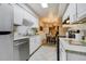 Bright kitchen with white cabinetry, stainless steel appliances, and an adjacent dining area at 9967 Lane St, Thornton, CO 80260