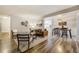 Inviting living room featuring hardwood floors and an open layout that flows into the dining area at 9967 Lane St, Thornton, CO 80260