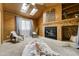 Charming living room featuring a wood-paneled vaulted ceiling with skylights and a cozy brick fireplace at 9967 Lane St, Thornton, CO 80260