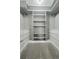 Bright walk-in closet featuring custom shelving and drawer organization, ideal for storage at 9967 Lane St, Thornton, CO 80260