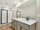 Bathroom featuring a double vanity with black fixtures, and a glass enclosed shower with white subway tile at 9484 Yampa St, Commerce City, CO 80022
