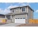 Charming two-story home featuring a neutral color palette, attached two car garage, and a covered front porch at 9484 Yampa St, Commerce City, CO 80022