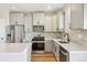 Bright kitchen featuring stainless steel appliances, gray cabinets, a stylish backsplash, and a kitchen island at 9484 Yampa St, Commerce City, CO 80022
