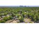Aerial view of the home nestled within a vibrant, tree-filled neighborhood with a downtown skyline view at 2731 W 42Nd Ave, Denver, CO 80211