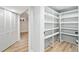Spacious basement with built-in white shelving, offering ample storage space, and adjacent room with closet at 2731 W 42Nd Ave, Denver, CO 80211