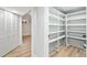 Basement storage area with vinyl floors and shelving and a glimpse of an egress window at 2731 W 42Nd Ave, Denver, CO 80211