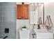 Bright bathroom showcasing a stylish sink, vanity, mirror, and complementing fixtures at 2731 W 42Nd Ave, Denver, CO 80211