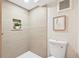 Modern bathroom featuring stylish wall tiles, a recessed shelf with plant, and new toilet fixture at 2731 W 42Nd Ave, Denver, CO 80211
