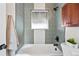 Updated bathroom featuring modern tile work, a bathtub, and sleek black hardware at 2731 W 42Nd Ave, Denver, CO 80211