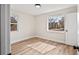 Bright bedroom featuring wood floors, fresh paint, and windows with neighborhood views at 2731 W 42Nd Ave, Denver, CO 80211