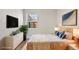 Cozy bedroom featuring a comfortable bed, a dresser, stylish decor, and a window providing natural light at 2731 W 42Nd Ave, Denver, CO 80211