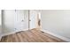 Open bedroom with sleek wood flooring, modern trim, and three doors at 2731 W 42Nd Ave, Denver, CO 80211
