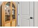 Detailed view of a cabinet with glass doors and woven wood on the lower doors, showcasing stylish home décor at 2731 W 42Nd Ave, Denver, CO 80211