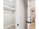 This closet includes a rack and leads to the bathroom, which features stylish wood vinyl flooring at 2731 W 42Nd Ave, Denver, CO 80211