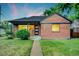 Charming brick home featuring manicured lawn and a modern front door with glass accents at 2731 W 42Nd Ave, Denver, CO 80211