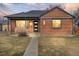 Inviting brick home with a well-lit entrance and a tidy front lawn at 2731 W 42Nd Ave, Denver, CO 80211