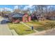 Charming brick home with a well-maintained lawn, mature trees, and an inviting curb appeal on a beautiful sunny day at 2731 W 42Nd Ave, Denver, CO 80211